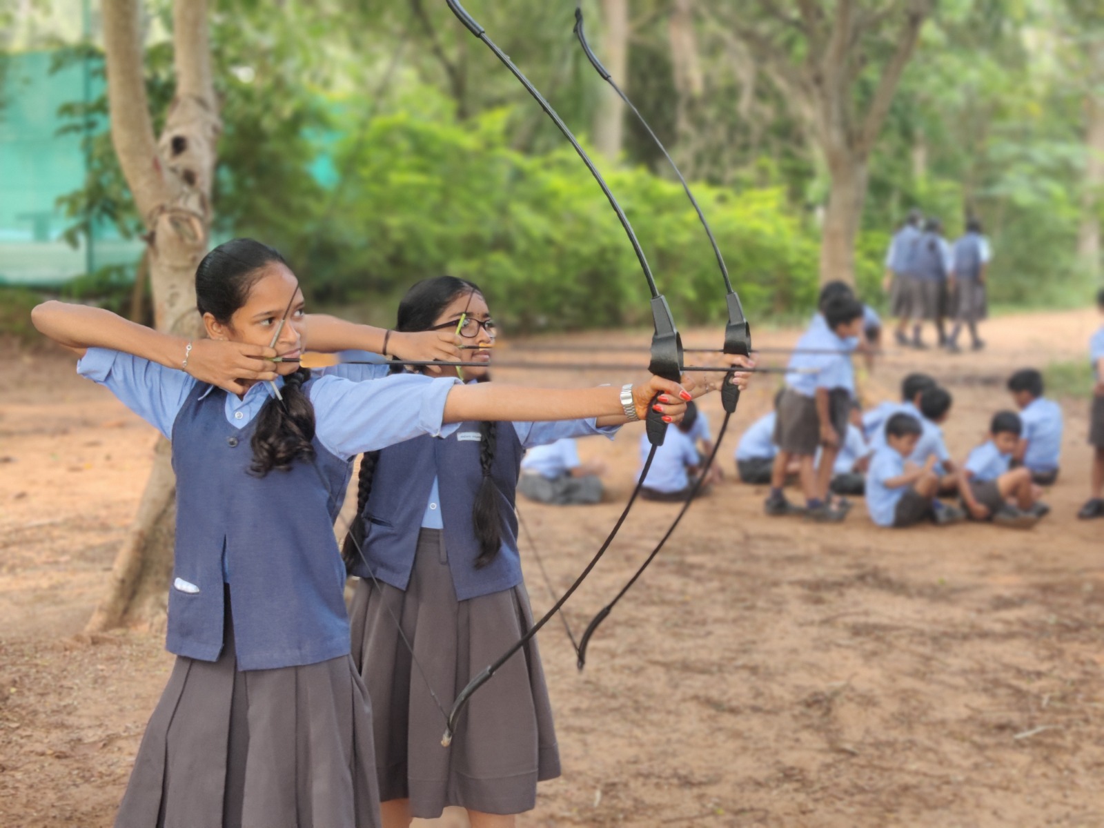 Students practicing archery outdoors